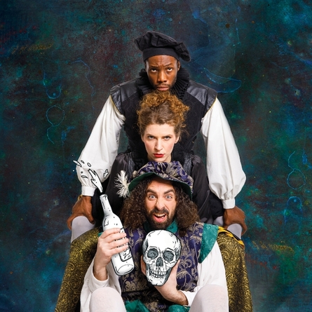 Three members of the cast, holding bottles of wine and the skull of Yorick.