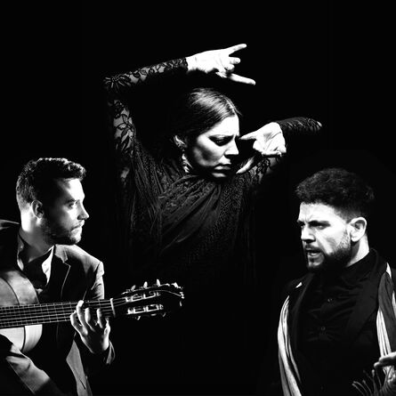 A woman dancing, a man with a guitar, a man singing